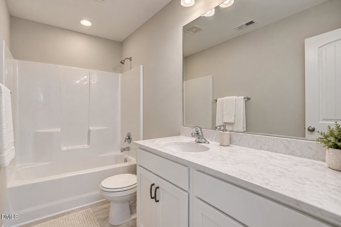 Daylit Hall Bathroom with White Vanity-1
