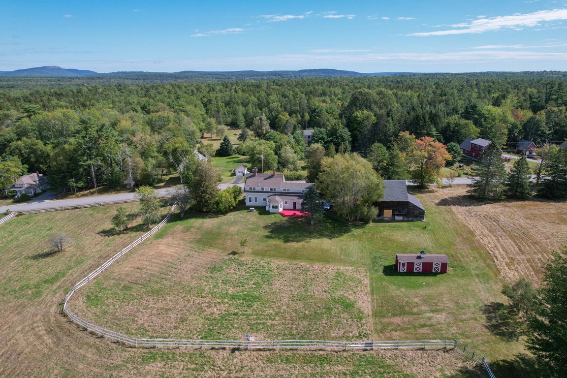 Back fenced pasture, house and barns.