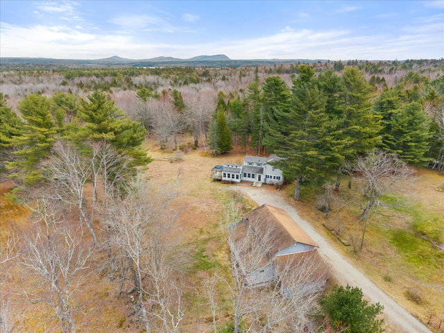 Note the open fields (grazing land) around the house and garage/barn.