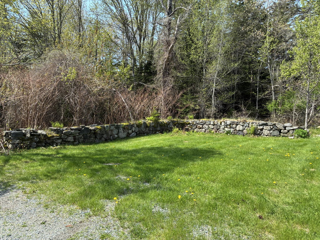 Stone wall next to garage.