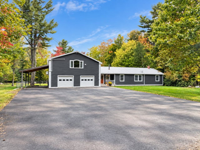 Front of house with Large paved driveway