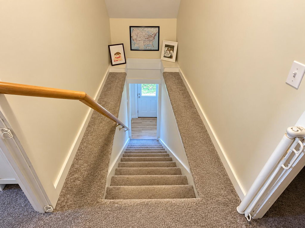 Warm Beige Stairwell with Framed Maps