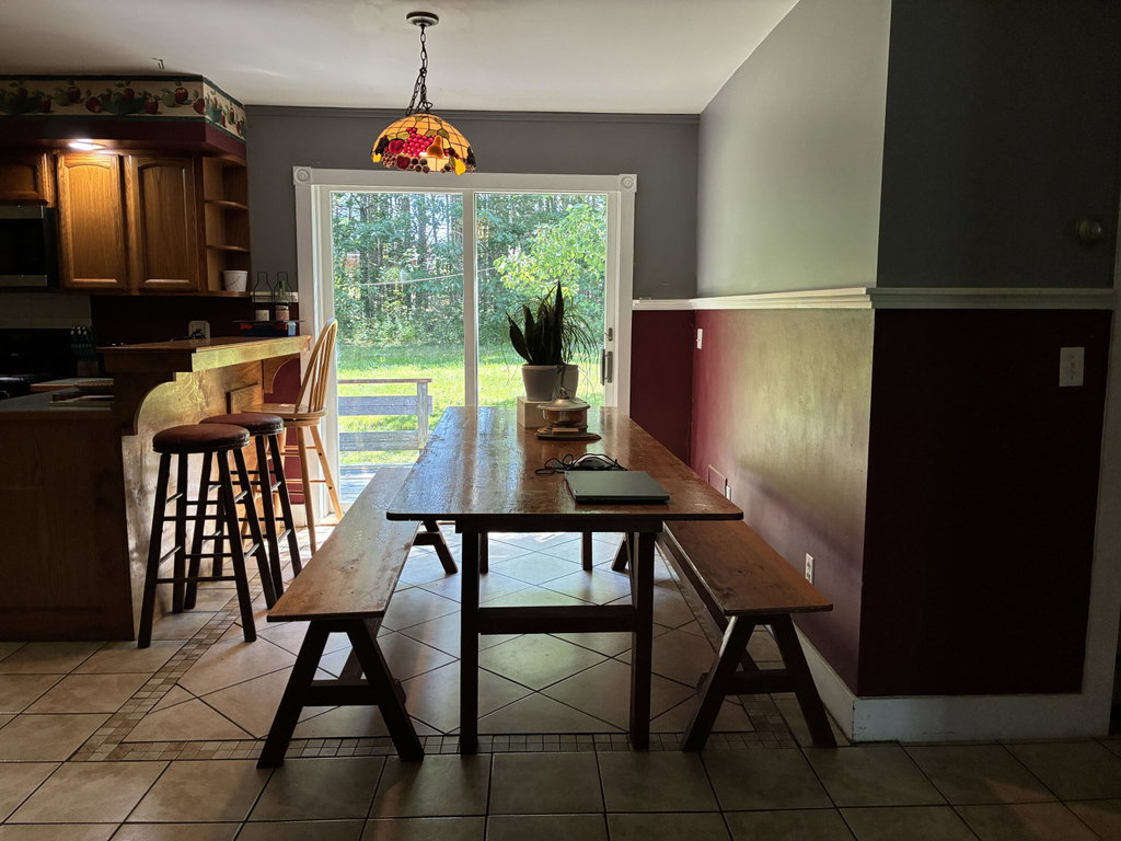 Dining area opening onto back deck.