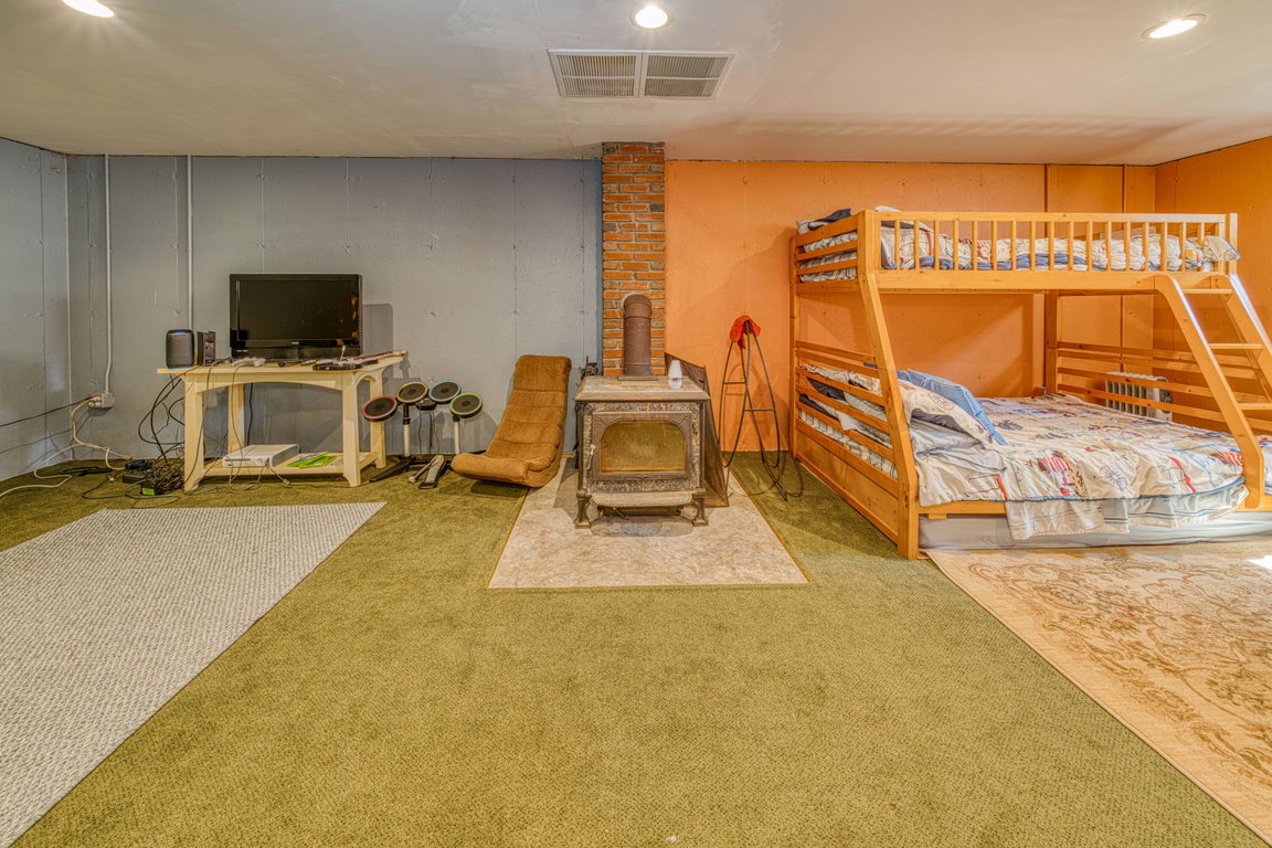 Lower level guest quarters with woodstov